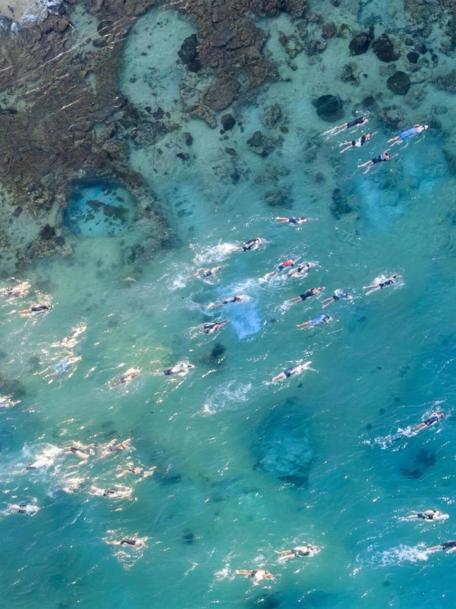 Aerial view of the IRONMAN Cozumel open-water swim over the turquoise reef
