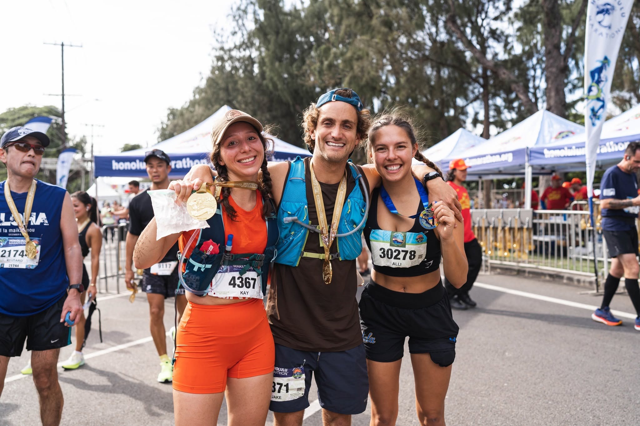 Runners celebrating together at the Honolulu Marathon finish line
