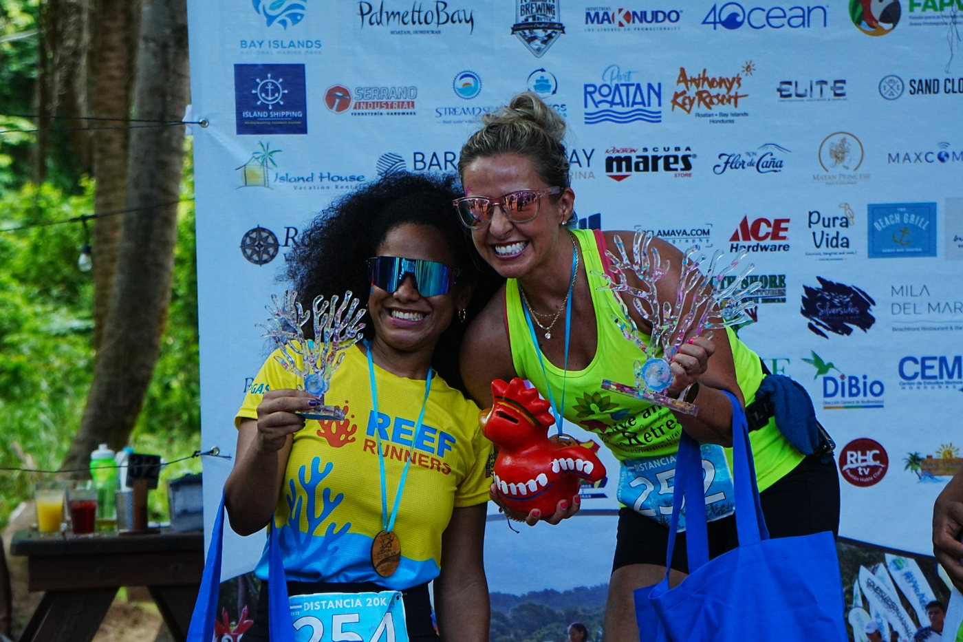 Runner crossing the finish line — race logistics in Roatán